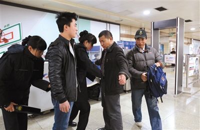 昨日，天安门西地铁站，两名安检员对乘客进行安检。新京报记者 韩萌 摄